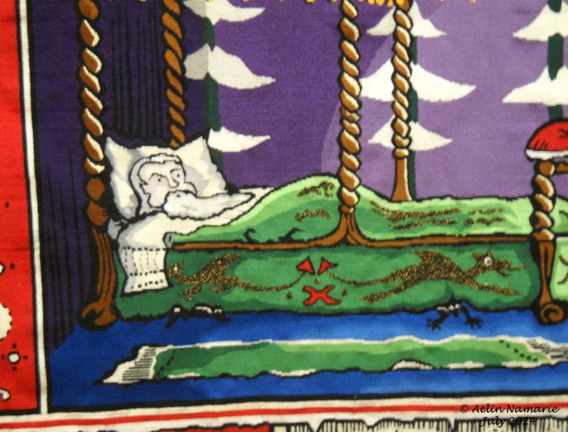 Christmas 1933 (detail)
A detail of the "Christmas 1933" tapestry. If you look carefully here (and also the curtains), metallic threads were used.
It was already a possibility in 1930's. Just it's not true gold like in medieval times.
You must know a tapestry isn't only wool. It can be also threads of gold or silver, or silk. Even the size of the thread isn't the same. You can have large threads for generalistic parts (for example a frame around a tapestry); or very fine threads for details, such has faces (the most apparent case is in a tapestry of the Miyazaki's movies) to enlight those parts.
Also, when you see face to face a tapestry, some seems very delicate when you look them, probably because of colors. At the point you wish to touch them to see how soft they are. It's of course forbidden to touch them (despite some visitors who don't care and aren't happy we elevate the voice on them to insist on the STOP) like for any museum, but there are samples available in museum, and also in the Tolkien exhibition. A tapestry - all of them in fact - is rigid under fingers, believe me! (I was allowed to clean few dusts, and despite my efforts, my fingers reached the tapestries).
